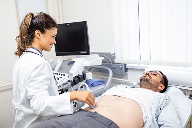 A skilled medical sonographer conducting a gallbladder ultrasonography in LA inside a modern, comfortable clinical room.