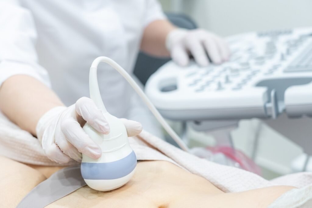 Patient undergoing a liver ultrasound examination at a medical imaging center in Los Angeles, with a sonographer using ultrasound equipment to assess liver health.