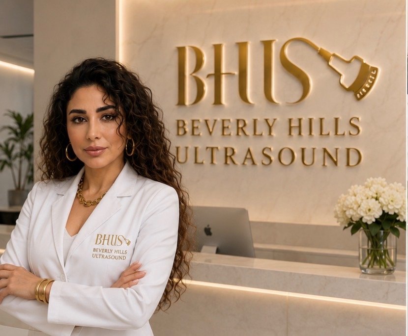 A certified sonographer near West Hollywood sitting at a modern desk inside the luxury Beverly Hills Ultrasound center.