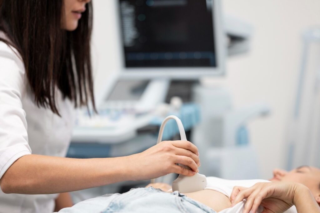 A medical professional performing a transabdominal scan on a patient to show what a pelvic ultrasound detects.